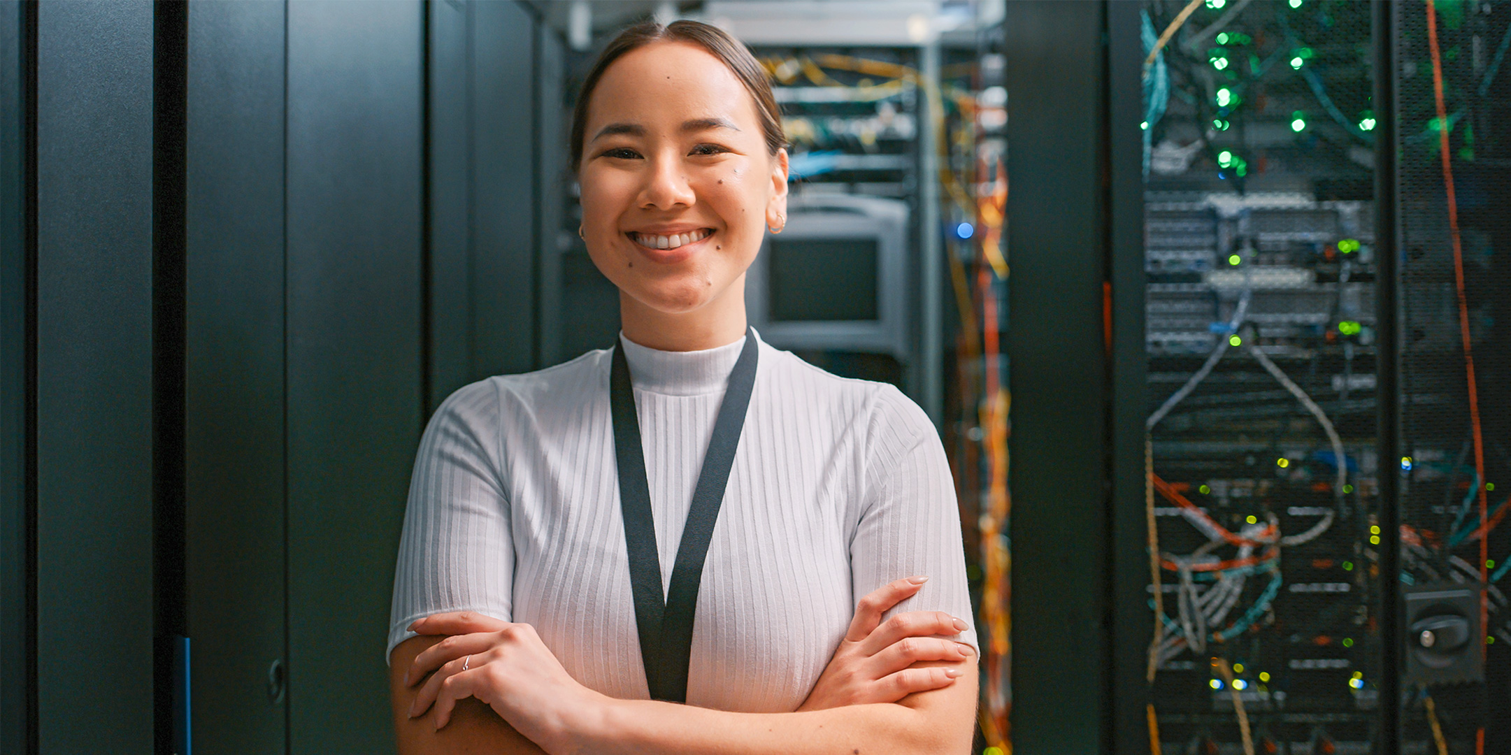 Woman smiling in camera in front of a server